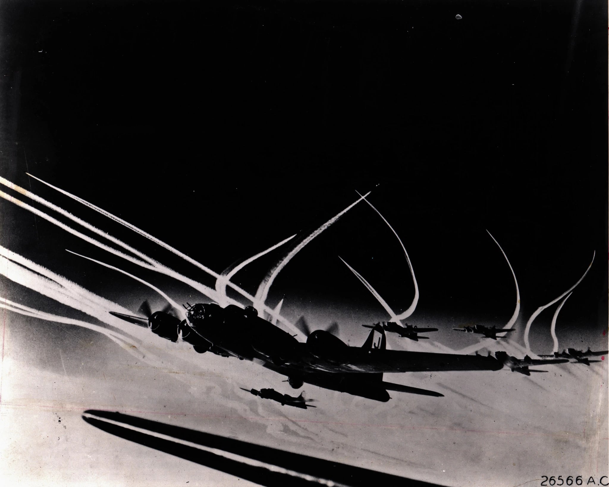 A formation of Boeing B-17F Flying Fortresses seen from below, trailing long contrails across a pale sky.