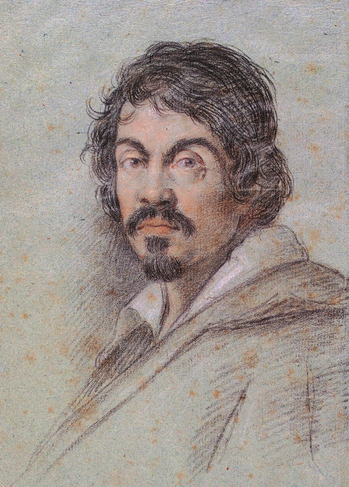 A chalk portrait head of Caravaggio on blue-grey paper: a dark-haired man in his thirties with heavy brows, a moustache and a small pointed beard, an open white collar and a loose cloak, looking slightly to one side.