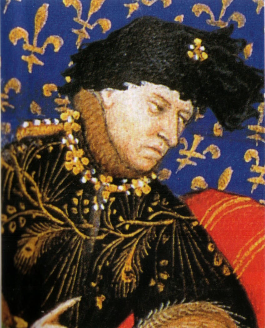 A detail from an illuminated manuscript. A middle-aged man with a heavy, tired face looks down and to one side. He wears a black fur-trimmed hat pinned with a gold fleur-de-lis and a black gown embroidered all over in gold, with two jewelled gold collars at his neck, against a deep blue ground scattered with gold fleurs-de-lis.