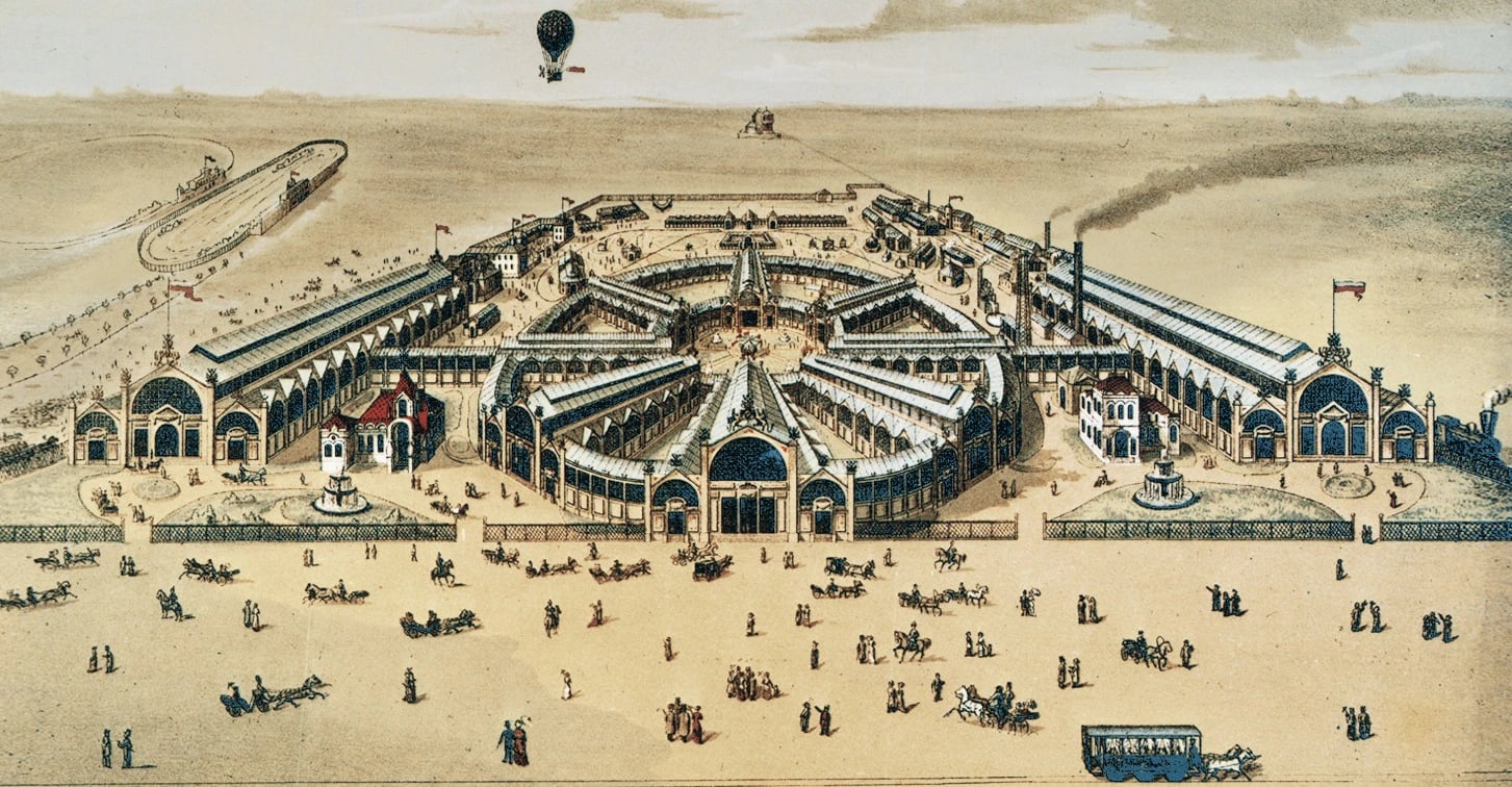 A hand-coloured bird's-eye lithograph of a large exhibition ground. Eight long glass-roofed pavilions radiate from a domed centre in a star, linked by two curving galleries, with smaller white and red pavilions, fountains and flagstaffs among them. Crowds, carriages and a horse tram cross a wide dusty forecourt in the foreground, and a balloon hangs over the ground behind.