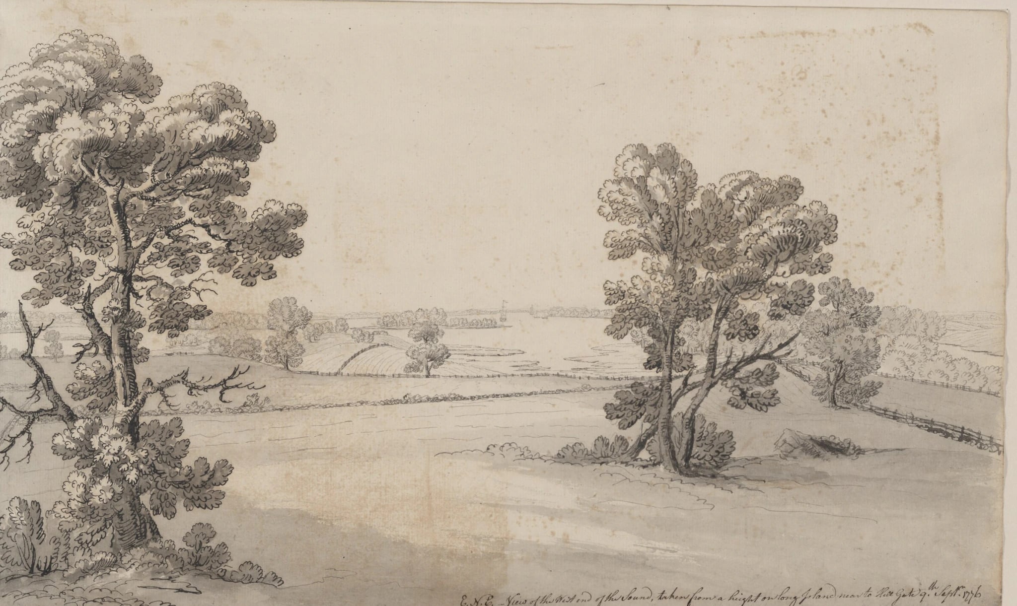 A grey wash drawing of open sloping ground on a height, framed by two oak trees, with split-rail fences running down to a broad stretch of water. A small sailing vessel lies in the channel and a low wooded shore closes the far side. An inked inscription runs along the bottom right of the sheet.